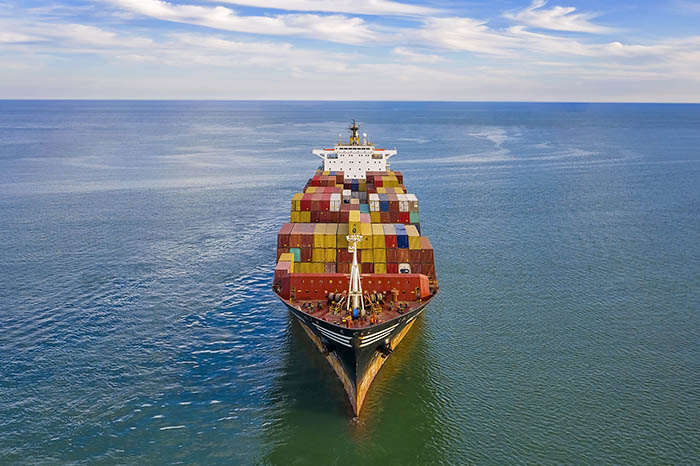 Aerial view of freight ship with cargo containers.